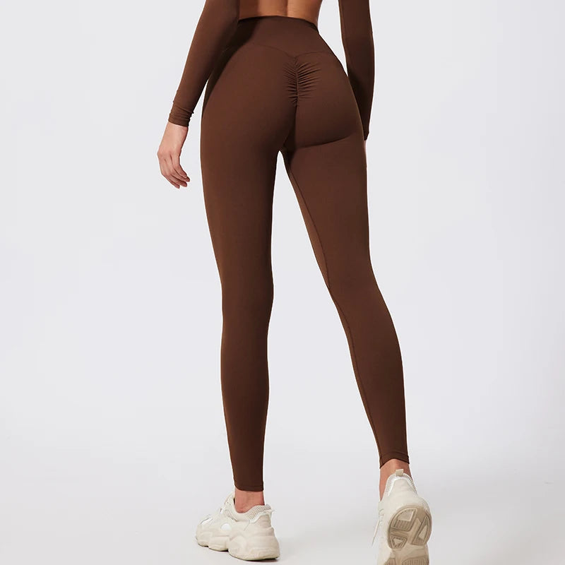 Brown leggings worn by a person on a white background