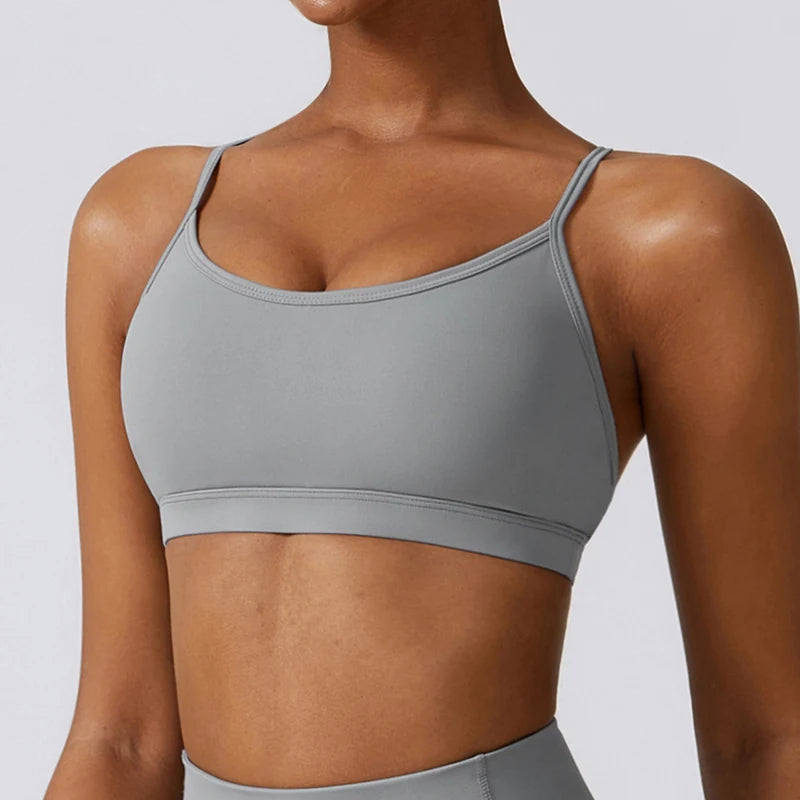 Gray sports bra worn by a person on a light gray background