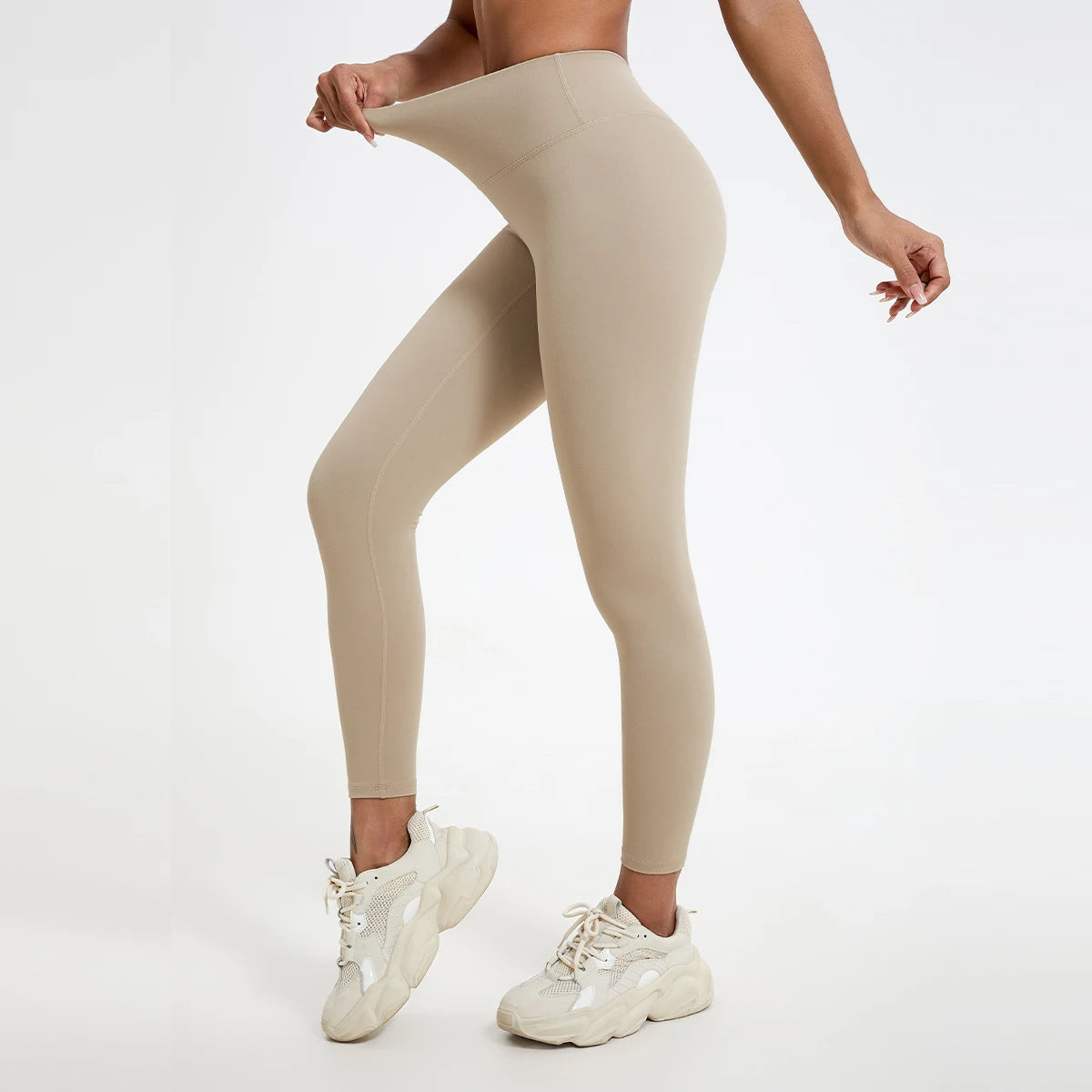 Beige leggings worn by a person on a white background