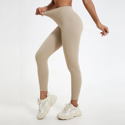 Beige leggings worn by a person on a white background