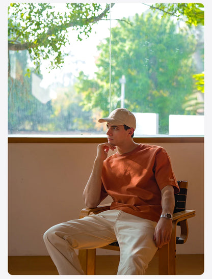 Person sitting in a chair by a window with a view of greenery