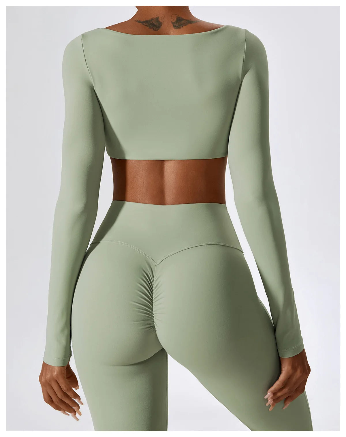 Green athletic outfit with long sleeves and leggings on a white background