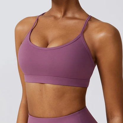 Purple sports bra worn by a person on a plain background