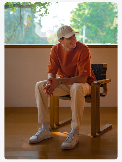 Person sitting on a chair indoors with a blurred outdoor background