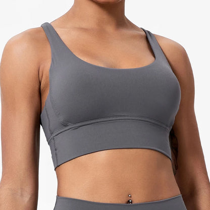 Gray sports bra worn by a person on a white background