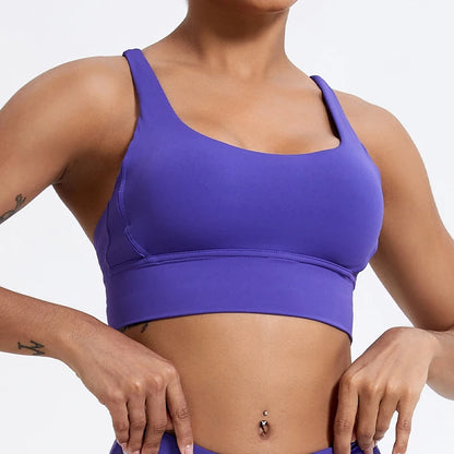 Person wearing a purple sports bra against a plain background
