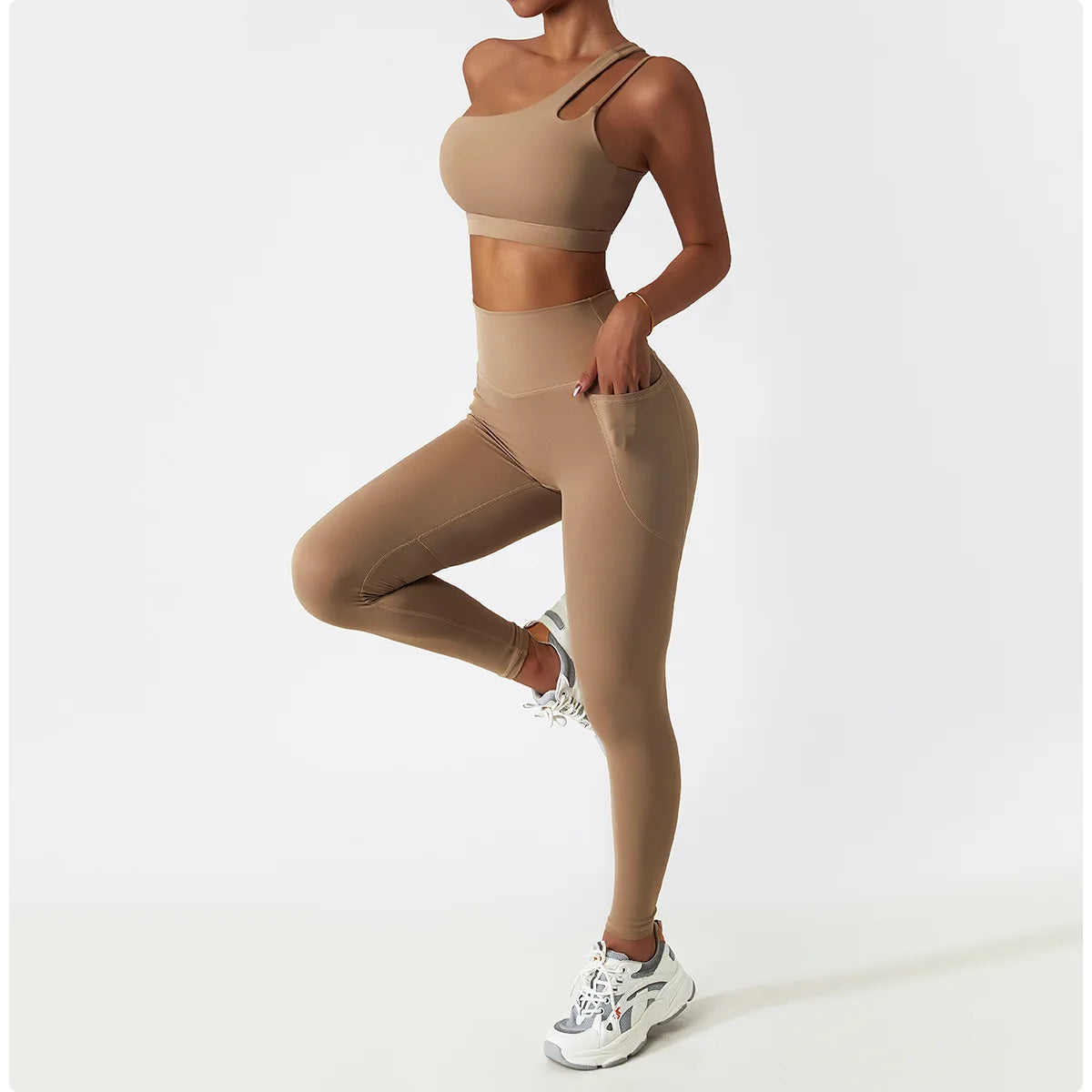 Person wearing a beige sports bra and leggings set on a white background