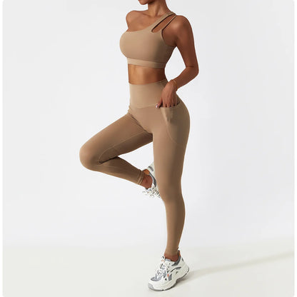 Person wearing a beige sports bra and leggings set on a white background