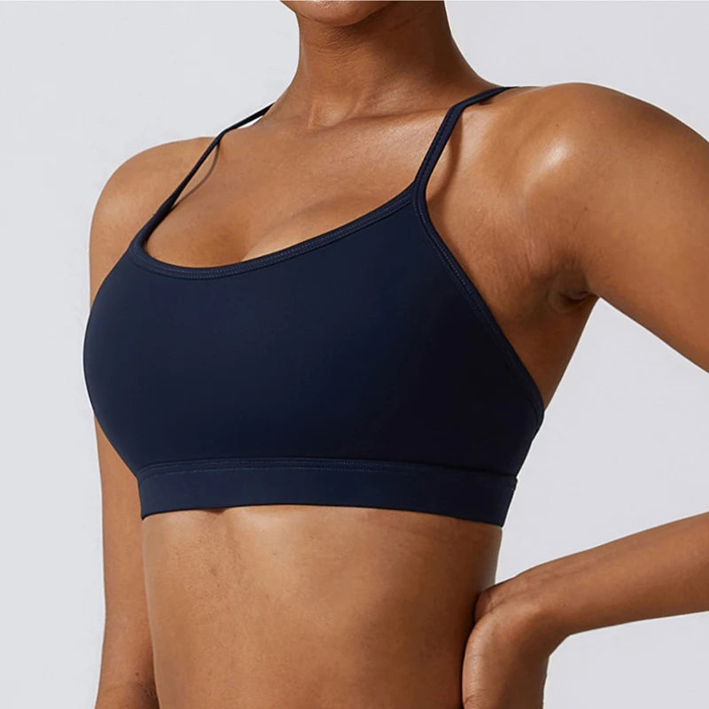 Navy blue sports bra worn by a person on a light gray background