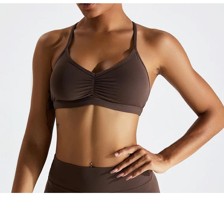 Brown sports bra and leggings on a plain background
