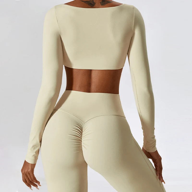Beige long-sleeve top and leggings set on a plain background